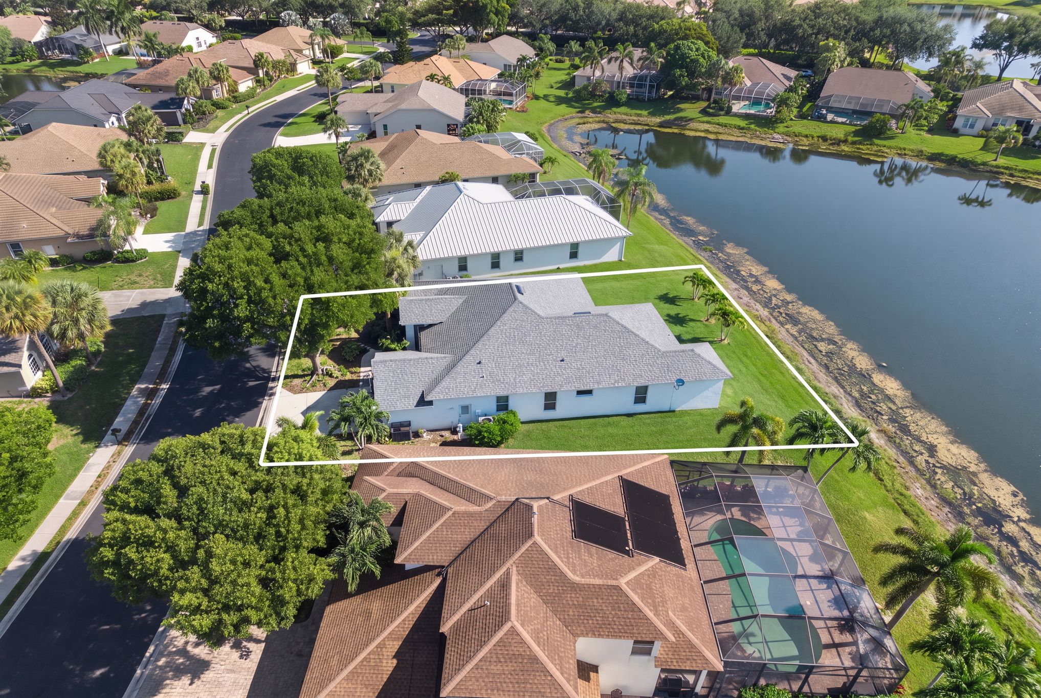 Aerial view of the home on its lake-view lot in The Orchards