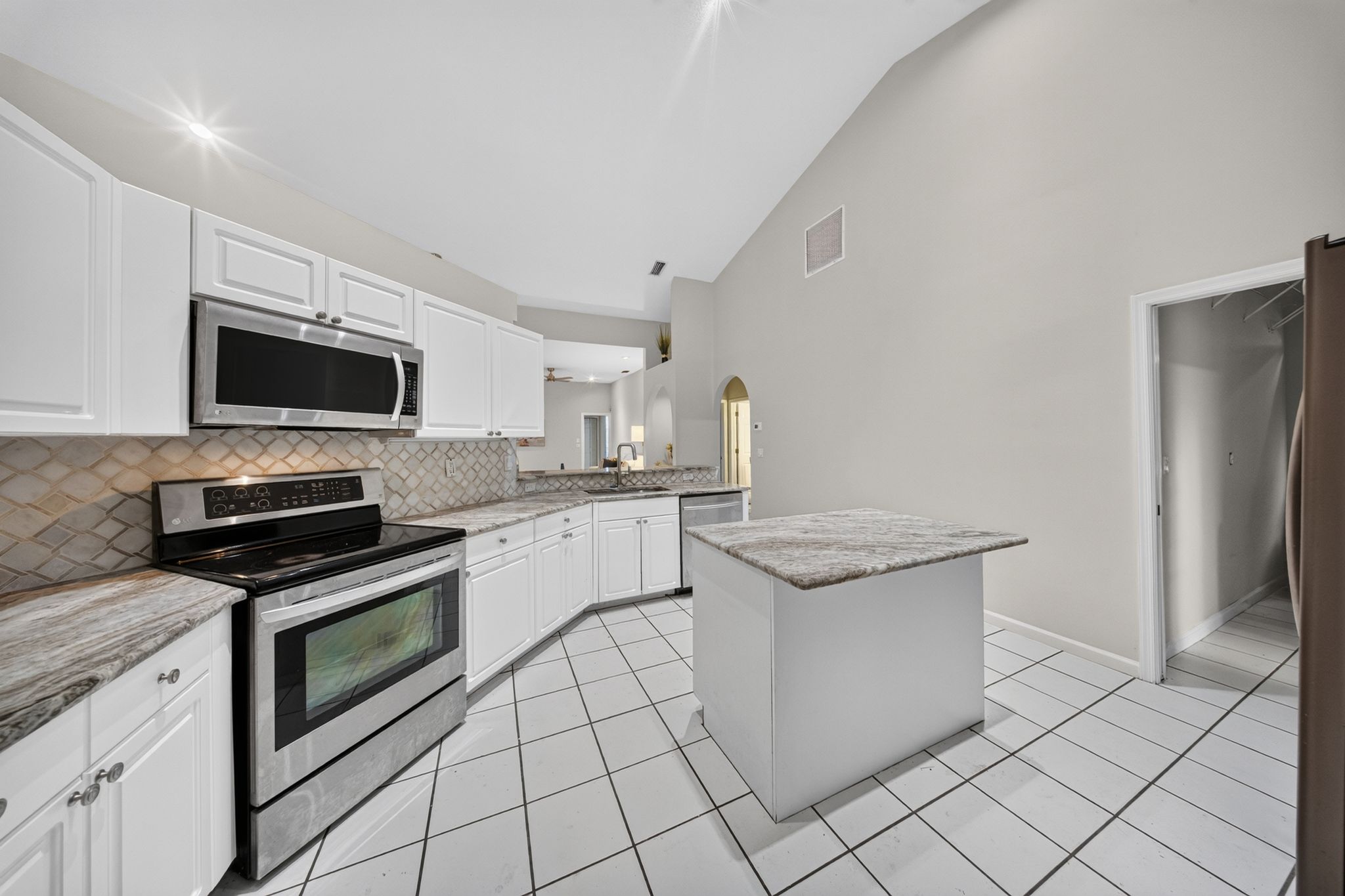 Renovated kitchen with island and stainless appliances